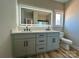 Bright bathroom with a modern vanity, dual sinks, and a well-lit mirror, perfect for a refreshing start at 15170 Cove Point Ln, Norwood, NC 28128
