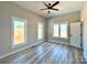 Inviting bedroom filled with natural light, showcasing the ample windows, neutral walls, and ceiling fan at 15170 Cove Point Ln, Norwood, NC 28128