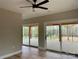 Bright bedroom featuring wood floors, and sliding doors to the deck with backyard views at 15170 Cove Point Ln, Norwood, NC 28128