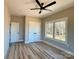 Clean bedroom featuring light walls, multiple windows, and spacious closet space for organized storage at 15170 Cove Point Ln, Norwood, NC 28128