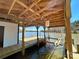 Modern boathouse featuring a boat lift for effortless boat launching and docking in a serene lake setting at 15170 Cove Point Ln, Norwood, NC 28128