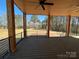 Spacious covered deck with ceiling fans and wood flooring, perfect for enjoying the outdoors at 15170 Cove Point Ln, Norwood, NC 28128