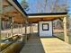 A private dock with a covered area, a lift, and a picturesque view of the tranquil water at 15170 Cove Point Ln, Norwood, NC 28128