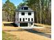 Stunning new construction home with a modern design and a well-manicured lawn in a serene wooded setting at 15170 Cove Point Ln, Norwood, NC 28128