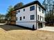 Exterior of a modern two-story home with a two-car garage and well-manicured lawn at 15170 Cove Point Ln, Norwood, NC 28128