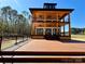A striking lake house with a large wooden deck, perfect for entertaining or relaxing by the water's edge at 15170 Cove Point Ln, Norwood, NC 28128