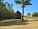 Beautiful exterior view of the new construction home, surrounded by lush greenery and a serene open yard at 15170 Cove Point Ln, Norwood, NC 28128