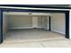 Spacious two-car garage featuring neutral paint, concrete floors, and additional doors for versatile use and storage at 15170 Cove Point Ln, Norwood, NC 28128
