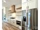 Gourmet kitchen boasts stainless steel appliances, custom cabinets, open shelving, and elegant quartz countertops at 15170 Cove Point Ln, Norwood, NC 28128
