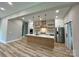 Modern kitchen with a central island, stainless steel appliances, custom cabinets, and stylish pendant lighting at 15170 Cove Point Ln, Norwood, NC 28128