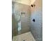 Contemporary shower boasting gray subway tile walls, a mosaic-tiled niche, and a sleek showerhead at 15170 Cove Point Ln, Norwood, NC 28128