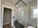 Modern glass shower with sleek fixtures, textured walls, and patterned tile flooring adding a touch of luxury at 15170 Cove Point Ln, Norwood, NC 28128
