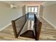 View of staircase with wood and metal railing leading to an upper level with a window at 15170 Cove Point Ln, Norwood, NC 28128