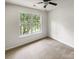 Cozy bedroom featuring a ceiling fan and a bright window with a view of the outdoors at 15188 Eric Kyle Dr, Huntersville, NC 28078