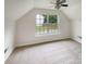 Bright bedroom with large window and neutral carpet, perfect for relaxation at 15188 Eric Kyle Dr, Huntersville, NC 28078