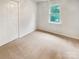 Clean bedroom with neutral carpet and a closet for storage space at 15188 Eric Kyle Dr, Huntersville, NC 28078
