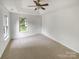 Comfortable bedroom featuring neutral carpet and natural light from a bright window at 15188 Eric Kyle Dr, Huntersville, NC 28078