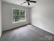Bright bedroom with neutral carpet and a view of trees through the window at 15188 Eric Kyle Dr, Huntersville, NC 28078