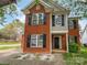 Charming two-story brick home with black shutters and a well-maintained front yard at 15188 Eric Kyle Dr, Huntersville, NC 28078