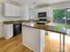 Bright kitchen with white cabinets, wood countertops, and a center island at 15188 Eric Kyle Dr, Huntersville, NC 28078