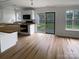 Kitchen with white cabinets, hardwood floors, and backyard access at 15188 Eric Kyle Dr, Huntersville, NC 28078