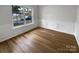 Living room with hardwood floors, wainscoting, and a large window at 15188 Eric Kyle Dr, Huntersville, NC 28078