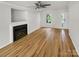 Open living room featuring a fireplace, hardwood floors, and a window view at 15188 Eric Kyle Dr, Huntersville, NC 28078