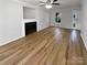 Bright living room with a fireplace, ceiling fan, and hardwood floors at 15188 Eric Kyle Dr, Huntersville, NC 28078