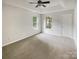 Spacious main bedroom with neutral carpet, two windows, and a ceiling fan at 15188 Eric Kyle Dr, Huntersville, NC 28078