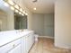 Bathroom featuring dual sinks, vanity with storage, tile floors, and large mirror at 1520 Royalty Cir, Statesville, NC 28625