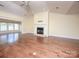 Spacious living room with a cozy fireplace, hardwood floors and large windows providing plenty of light at 1520 Royalty Cir, Statesville, NC 28625