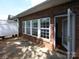 The red brick patio features windows offering natural light and a seamless transition to indoor living at 1520 Royalty Cir, Statesville, NC 28625