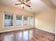 Sun Room area with three large windows, fan, and wood floors at 1520 Royalty Cir, Statesville, NC 28625
