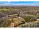 Aerial shot of the property nestled among mature trees and lush landscaping at 1595 Cheatham Ford Rd, Hiddenite, NC 28636