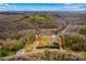 Expansive aerial view of property showcasing multiple buildings, green space, and natural surroundings at 1595 Cheatham Ford Rd, Hiddenite, NC 28636