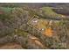Aerial view showcasing the property, surrounding greenery, and water feature at 1595 Cheatham Ford Rd, Hiddenite, NC 28636