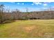 Expansive lot with grassy yard, mature trees, and outbuilding at 1595 Cheatham Ford Rd, Hiddenite, NC 28636