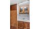 Bathroom features wood cabinets, white countertop, and mirrored vanity at 1595 Cheatham Ford Rd, Hiddenite, NC 28636