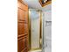 Bathroom featuring wood cabinets, glass shower doors, and white toilet at 1595 Cheatham Ford Rd, Hiddenite, NC 28636