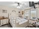 Cozy bedroom featuring natural light, a ceiling fan, and a comfortable bed at 1595 Cheatham Ford Rd, Hiddenite, NC 28636