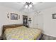 Bedroom with ceiling fan, bed and dresser with quilt and natural light at 1595 Cheatham Ford Rd, Hiddenite, NC 28636