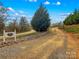 Gravel driveway leads to property with lush landscaping and mature trees at 1595 Cheatham Ford Rd, Hiddenite, NC 28636