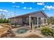 Back exterior view featuring a water fountain, landscaping, and outdoor seating area at 1595 Cheatham Ford Rd, Hiddenite, NC 28636