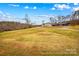 Exterior view showcasing a well-maintained lawn and multiple outbuildings at 1595 Cheatham Ford Rd, Hiddenite, NC 28636