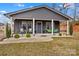 Charming home with a covered front porch, decorative columns, and a manicured lawn at 1595 Cheatham Ford Rd, Hiddenite, NC 28636