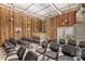 A view of a sanctuary with wooden walls, rows of gray chairs, and a raised platform at 1595 Cheatham Ford Rd, Hiddenite, NC 28636