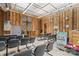A view of a sanctuary with wooden walls, rows of gray chairs, and a raised platform at 1595 Cheatham Ford Rd, Hiddenite, NC 28636