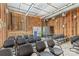 A view of a sanctuary with wooden walls, rows of gray chairs, and a raised platform at 1595 Cheatham Ford Rd, Hiddenite, NC 28636