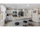 Kitchen view showcasing modern gray cabinets, a granite island, stainless appliances, and updated lighting at 1595 Cheatham Ford Rd, Hiddenite, NC 28636