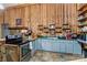 Cozy kitchen features wooden walls, green counters, and stainless steel appliances at 1595 Cheatham Ford Rd, Hiddenite, NC 28636